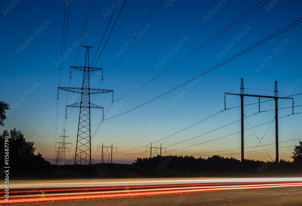 Electricity transmission power lines at sunset High voltage tower.