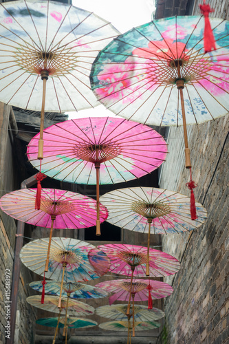 umbrella decorations hanging over the lane