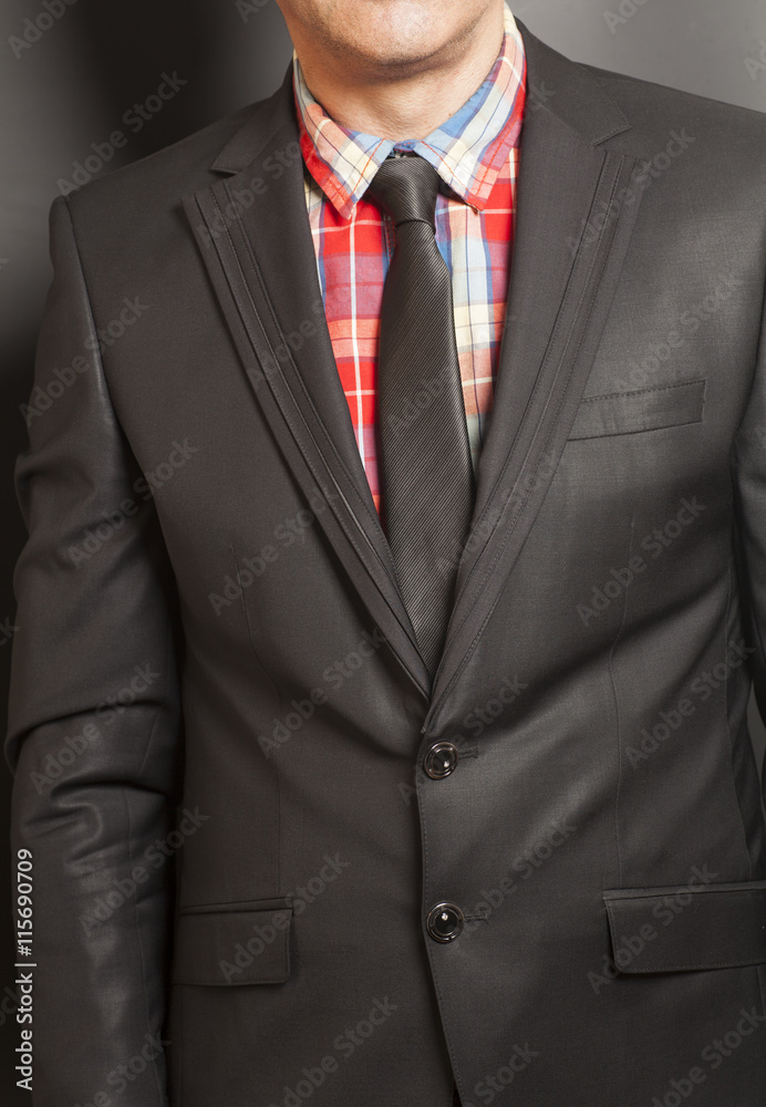 Man in black suit and black tie on a black background Man in black suit and black tie on a black background