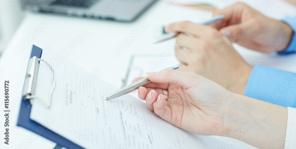 Young doctor explains how to fill out a medical form. Partnership, trust and medical ethics concept Young doctor explains how to fill out a medical form. Partnership, trust and medical ethics concept