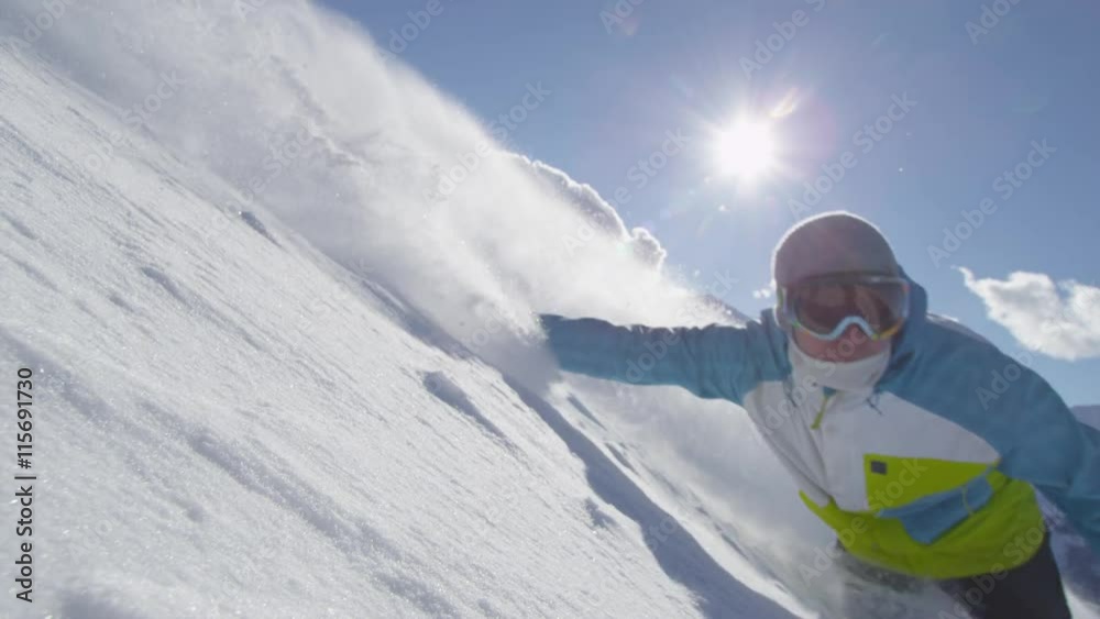 SLOW MOTION: Snowboarder boarding in fresh snow