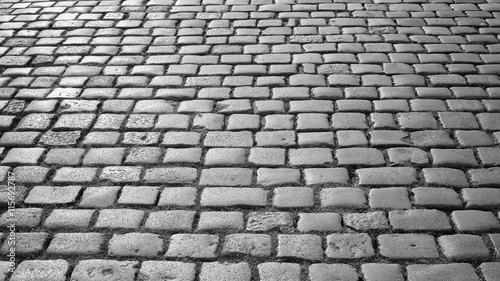 Black and white photo of cobblestone pavement