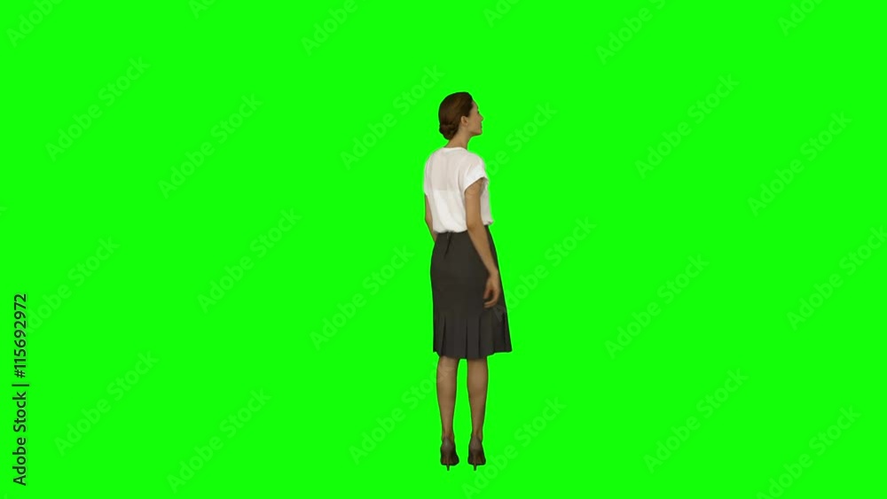Businesswoman standing and pointing on green screen background Businesswoman standing and pointing on green screen background