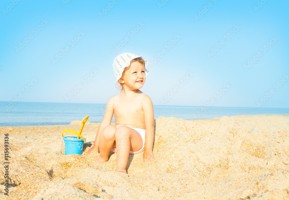 Baby playing on the sandy beach