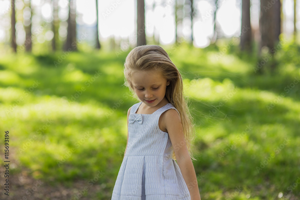 portrait of a beautiful girl with long blond hair in a light dress, walking in the woods on a sunny day portrait of a beautiful girl with long blond hair in a light dress, walking in the woods on a sunny day