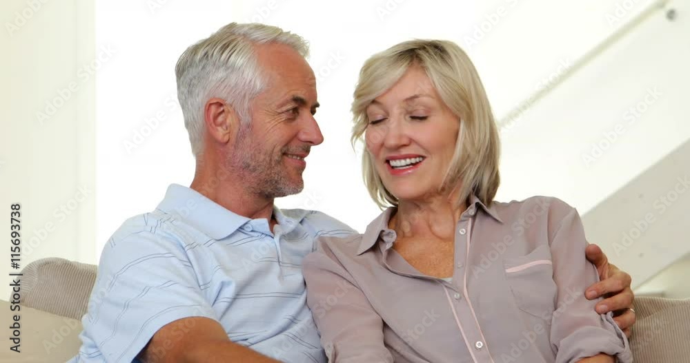 Couple chatting on the couch Couple chatting on the couch