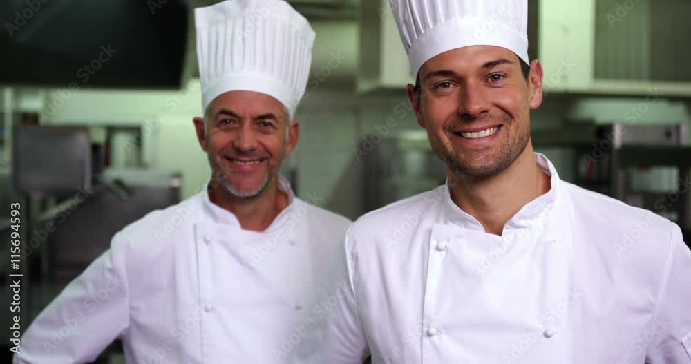 Two smiling chefs giving ok sign to camera Two smiling chefs giving ok sign to camera