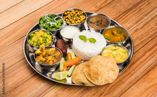 indian thali, indian food thali, punjabi thali, punjabi food thali, north indian thali, roti, gulab jamum, paneer, chole, pulav or veg biryani, raita or rayta, daal tadka or tarka combination photo