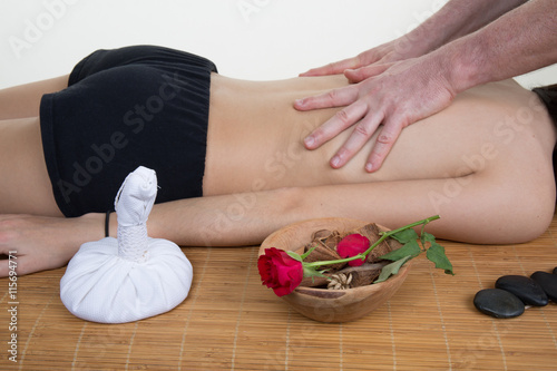 Young woman lying on a massage table and is being massaged