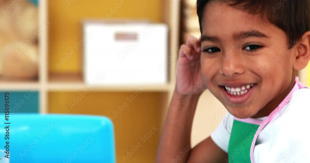 Cute little boy painting at table in classroom Cute little boy painting at table in classroom