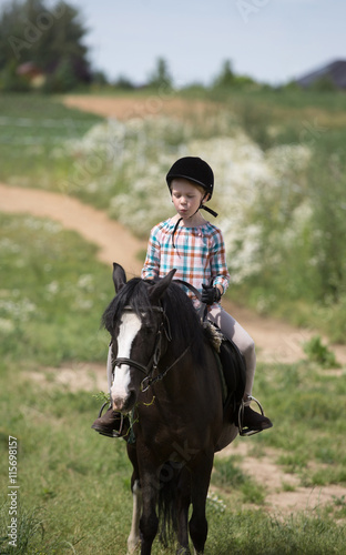 happy young girl riding horse 