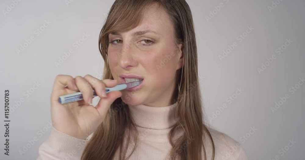 Young woman brushing her teeth Young woman brushing her teeth