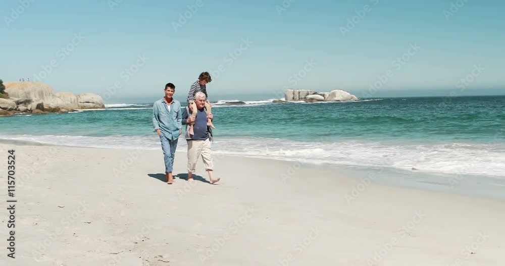 Young boy with his father and grandfather on the beach Young boy with his father and grandfather on the beach