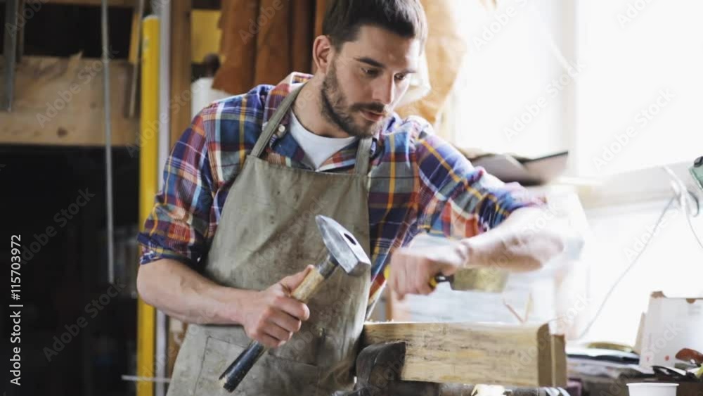 carpenter with chisel working at workshop