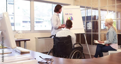Wallpaper Mural Casual businessman presenting graph to colleagues in the office Torontodigital.ca