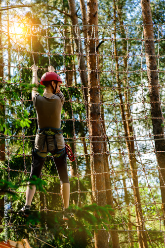 adventure climbing high wire park - Young woman on course in mou