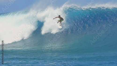 SLOW MOTION: Extreme pro surfer surfing big tube barrel wave