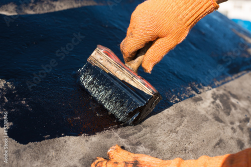 worker making waterproofing. photo