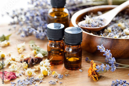 essential oils with dried herbs photo