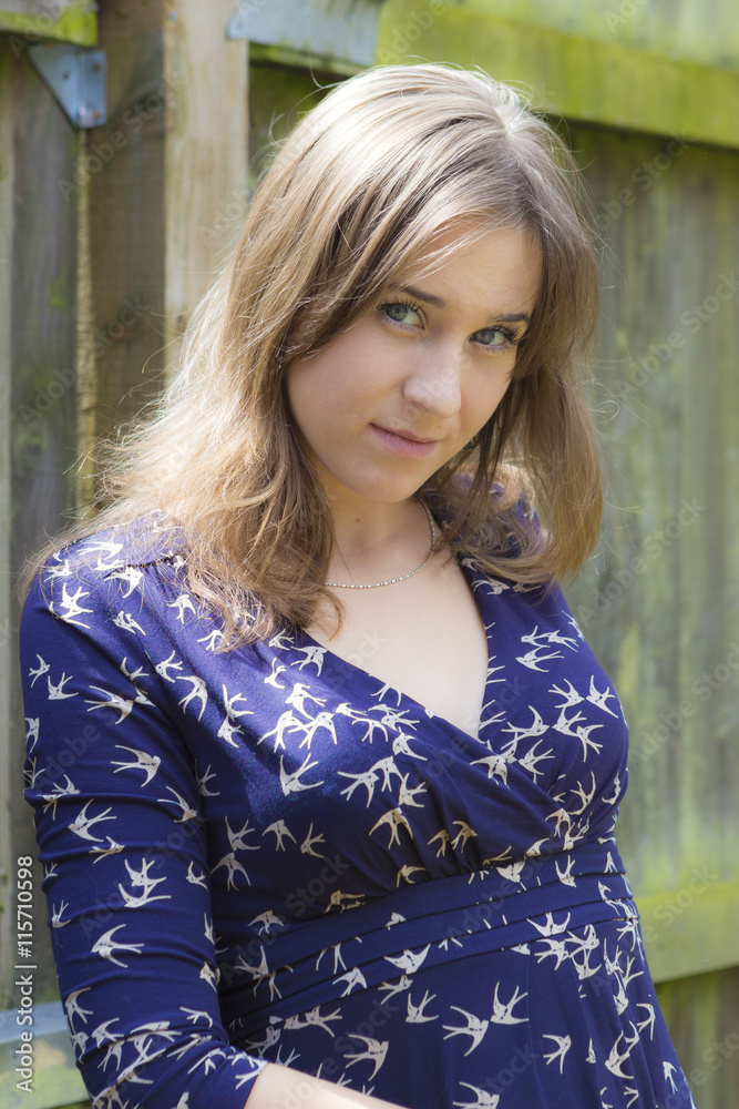 Fototapeta premium Long-haired young woman in dress outdoors