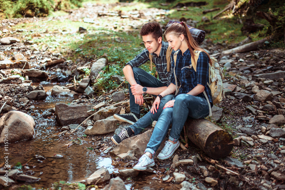 A couple of tourists Hiking backpacks are viewing beautiful landscape mountain river