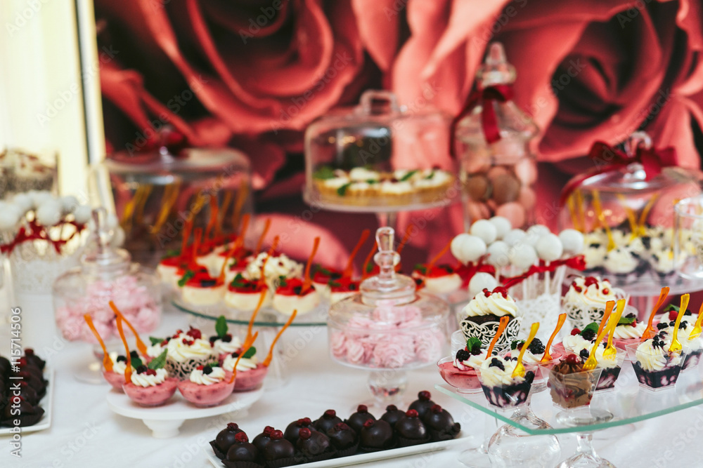 Chocolates and fruit yogurts stand on a wedding buffet