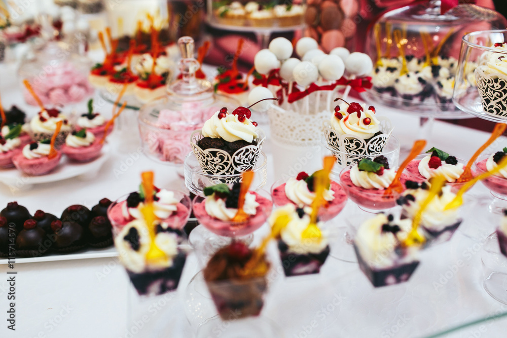 Different kinds of sweets and pastry stand on a rich wedding buf