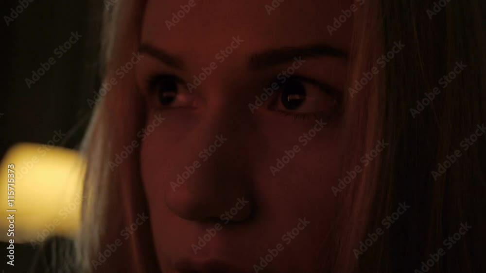 Close up young girl looking at tv screen concentrating Close up young girl looking at tv screen concentrating