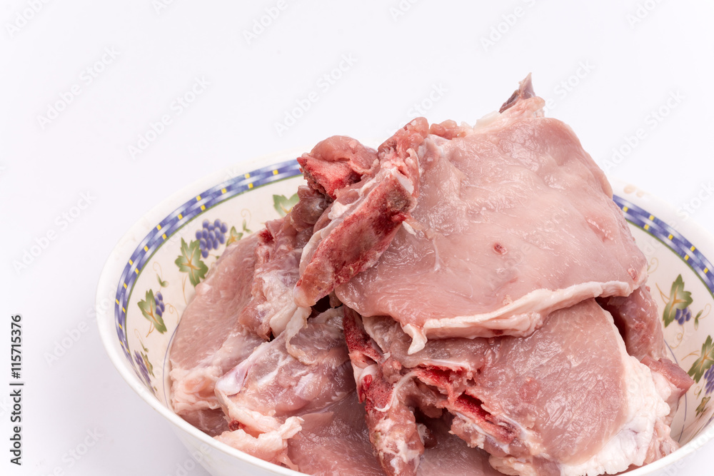 Pile of raw pork chops in the bowl over white background Pile of raw pork chops in the bowl over white background