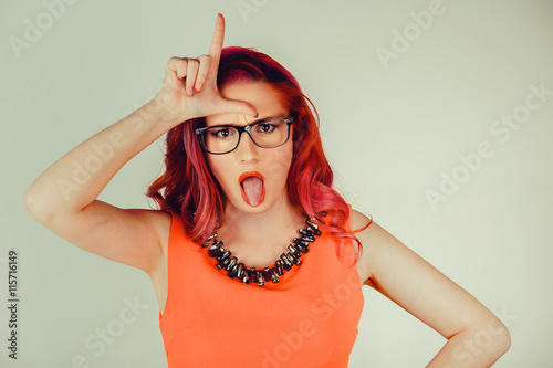 Woman showing loser sign photo