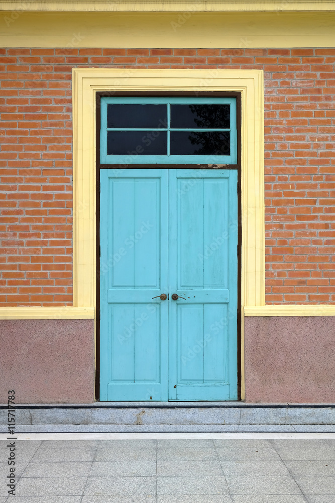 Antique door with brick wall