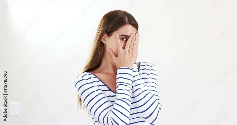 Woman hiding her face with her hands Woman hiding her face with her hands