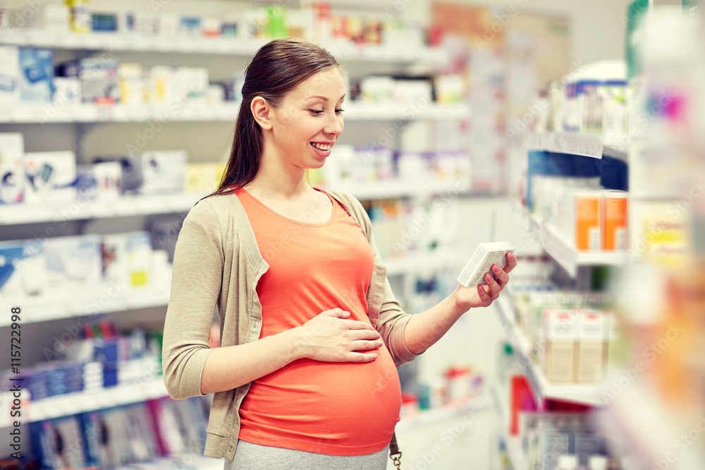 happy pregnant woman with medication at pharmacy