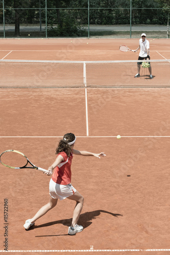 Junior female tennis player working with her coach © Microgen