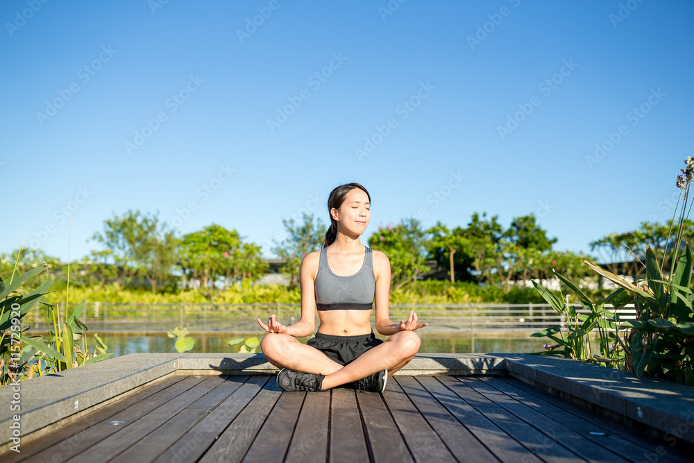 Young woman doing yoga exercise outdoor
