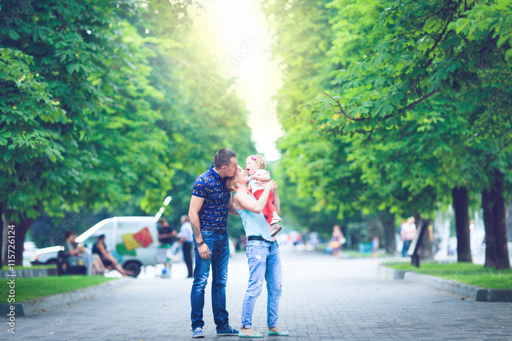 Happy family having weekend in summer park