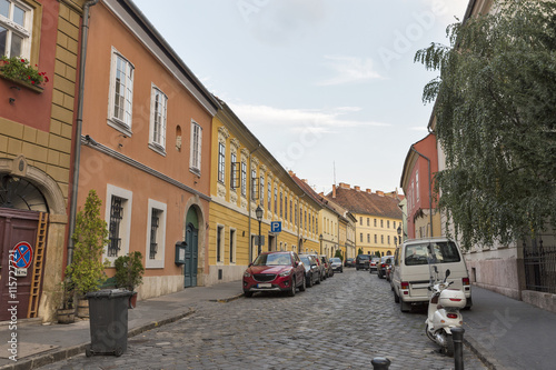 Photography Old narrow street with parked cars in Budapest, Hungary.