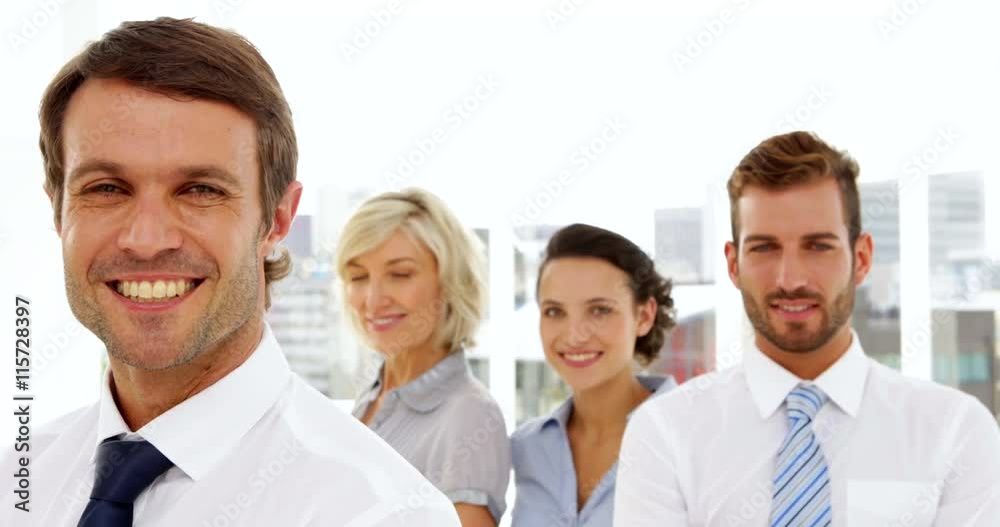 Happy business team smiling at the camera Happy business team smiling at the camera