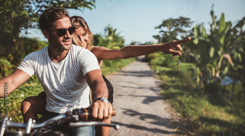 Beautiful young couple riding motorbike