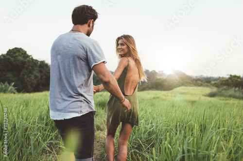 Young couple walking along country path