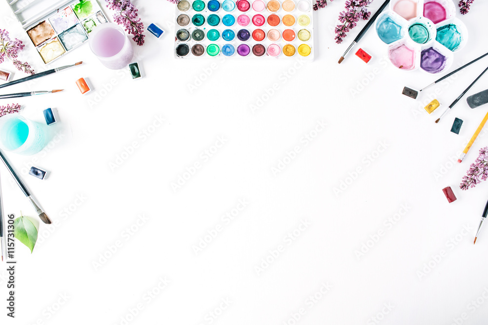 Obraz premium Watercolor and brushes at white background. Flat lay, top view