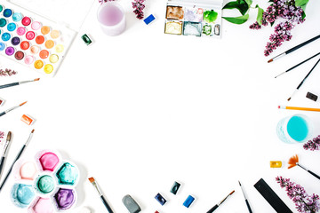 Watercolor and brushes at white background. Flat lay, top view
