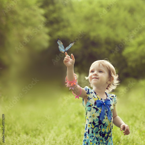 Happy girl sat on the arm of a beautiful butterfly