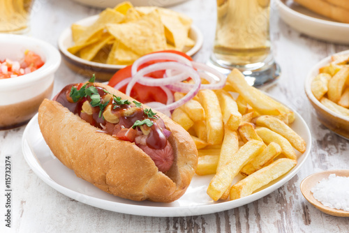 hot dogs with French fries, beer and snacks, close-up