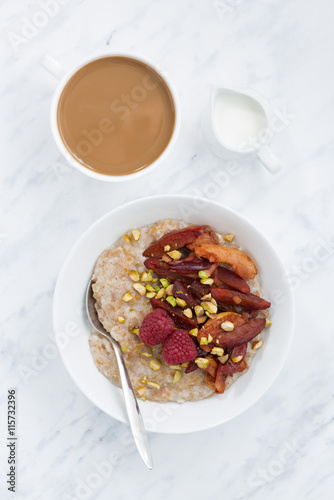 oatmeal with baked fruit and fresh coffee with milk, vertical