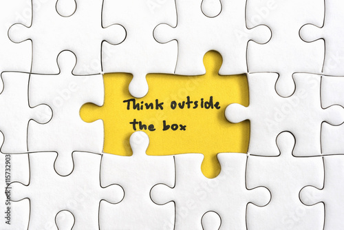Jigsaw puzzle piece with two missing and hand writing letters word think outside the box Quotes business concept