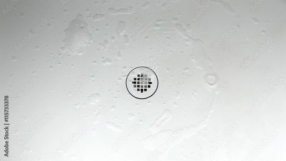 Soapy water going down the shower drain in slow motion Stock Video