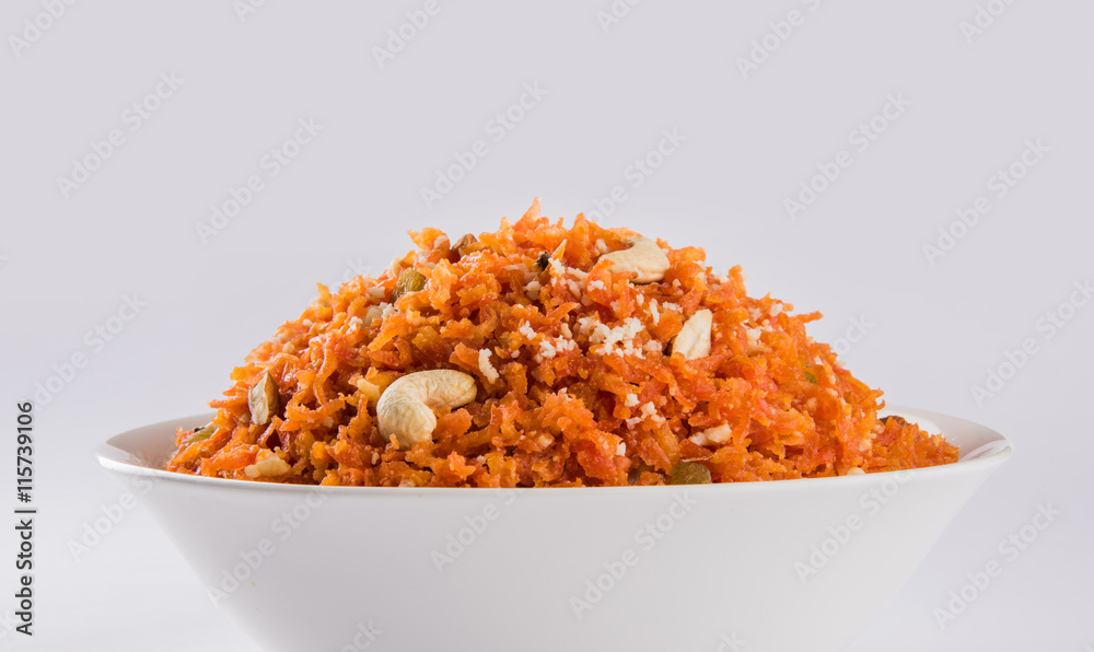 tasty gajar halwa or gajar ka halwa made up or fresh carrot, sugar and milk. decorated with almond or badam, cashewnuts and pistachios, favourite north indian dessert usually served in weddings - obrazy, fototapety, plakaty 