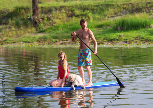 Outdoor recreation. Two in the boat and a dog.