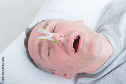 Snoring man in bed